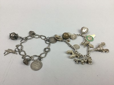 Lot 150 - A LOT OF TWO SILVER CHARM BRACELETS, A GOLD BROOCH, AND MIXED COINAGE