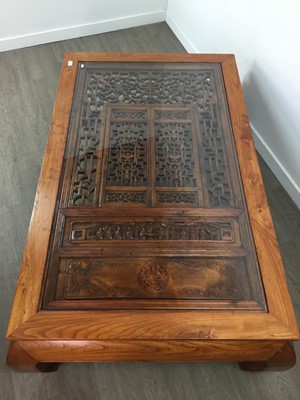 Lot 1061 - A CHINESE WINDOW FRAME SET INTO A LOW ELM TABLE