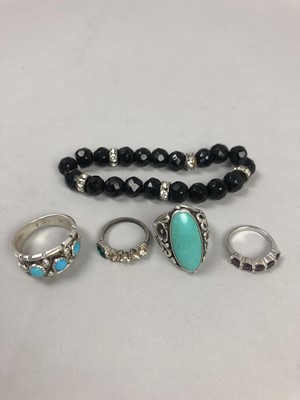 Lot 532 - A SILVER DRESS RING, THREE OTHER RINGS AND A BRACELET