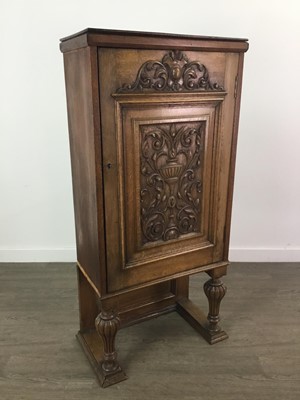 Lot 653 - A CARVED OAK SINGLE DOOR CUPBOARD