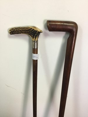 Lot 672 - A HORN HANDLED WALKING STICK, ANOTHER STICK AND A PARASOL