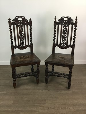 Lot 601 - A PAIR OF EARLY 20TH CENTURY CARVED OAK HALL CHAIRS