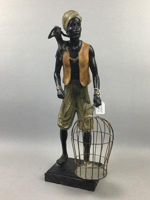 Lot 621 - AN EARLY 20TH CENTURY BLACKAMOOR FIGURE ALONG WITH A PAIR OF CANDLESTICKS