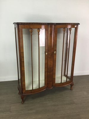 Lot 128 - A WALNUT DOUBLE BOW FRONTED DISPLAY CABINET
