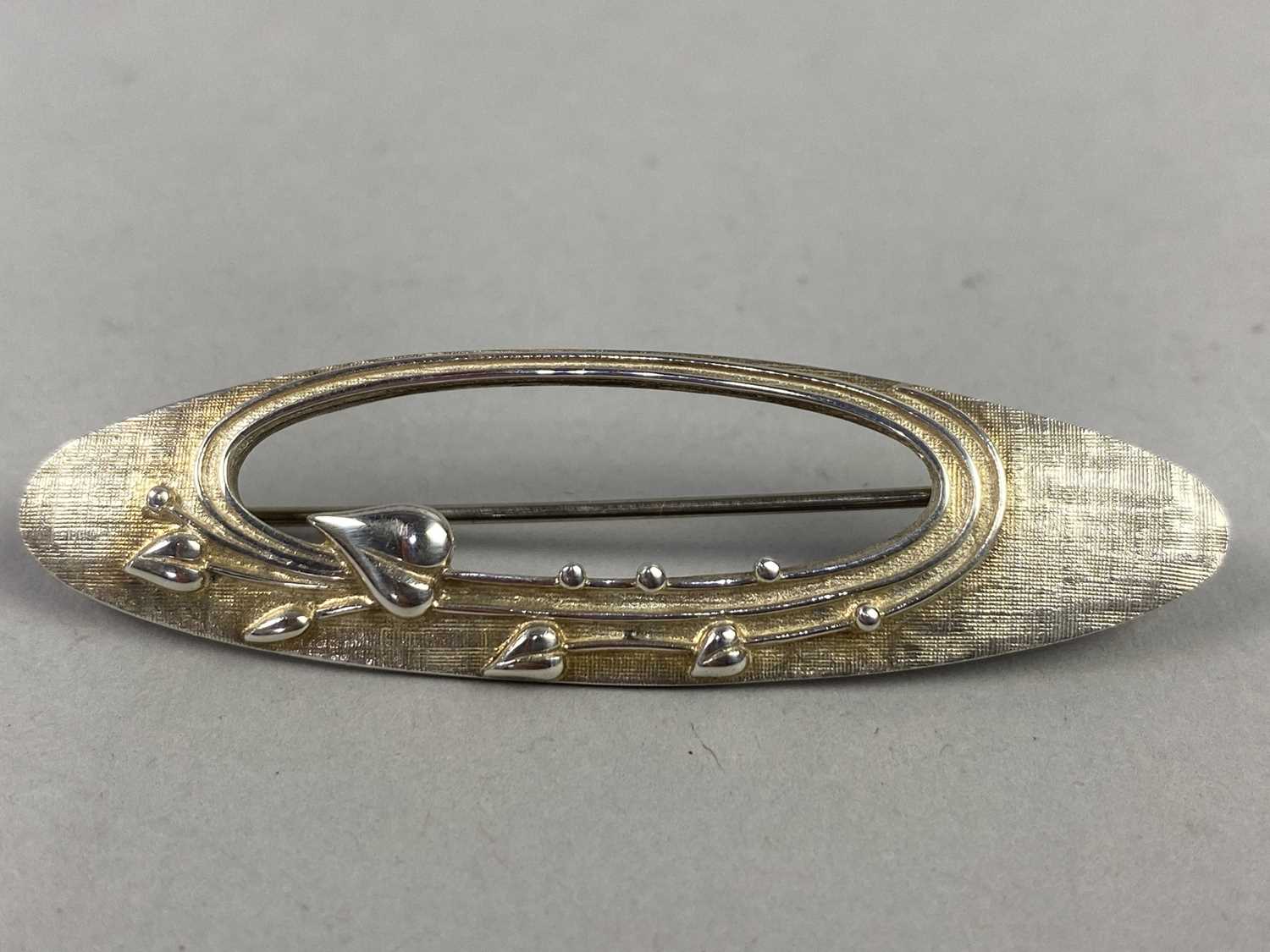 Lot 82 - AN OLA M. GORIE 'MAY QUEEN' SILVER BROOCH ALONG WITH A SILVER AND GOLD STICK PIN