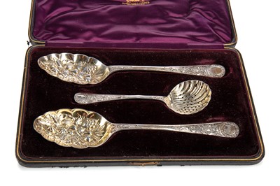 Lot 151 - A PAIR OF VICTORIAN SILVER AND PARCEL GILT BERRY SPOONS AND STRAINING SPOON