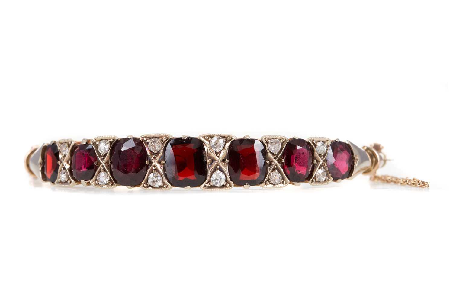 Lot 657 - A GARNET AND DIAMOND BANGLE