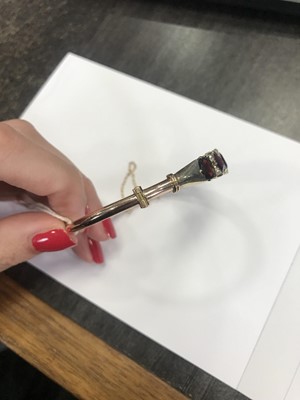 Lot 657 - A GARNET AND DIAMOND BANGLE