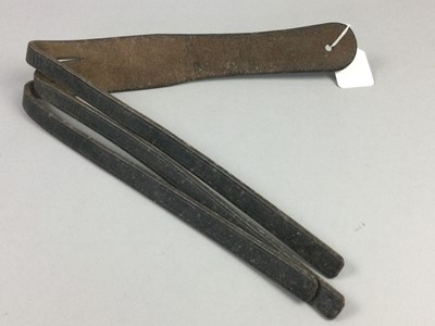 Lot 389 - A LEATHER SCHOOL TAWSE ALONG WITH A MORTAR BOARD