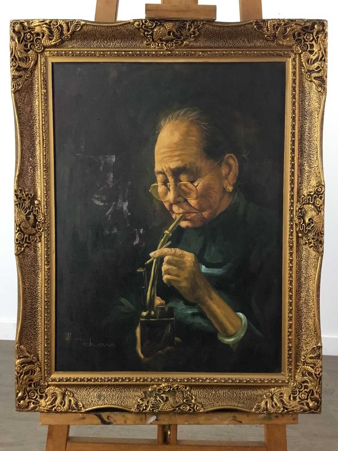 Lot 1175 - AN OIL PAINTING OF A WOMAN SMOKING AN OPIUM PIPE BY W. H. CHAN