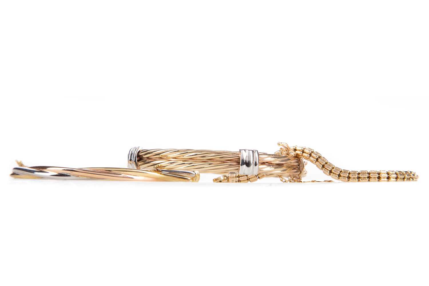 Lot 1233 - TWO GOLD BANGLES AND A BRACELET