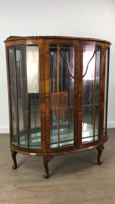 Lot 234 - A WALNUT BOW FRONT DISPLAY CABINET