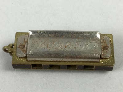 Lot 474 - A HOHNER MINIATURE MOUTH ORGAN AND WHISTLE