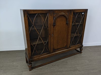 Lot 196 - AN OAK THREE DOOR BOOKCASE