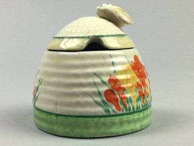 Lot 29 - A CLARICE CLIFF CROCUS PRESERVE JAR AND COVER