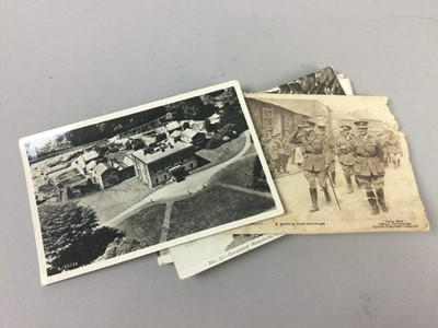 Lot 143 - A GROUP OF WWI POSTCARDS ALONG WITH ASSORTED CAP AND LAPEL BADGES