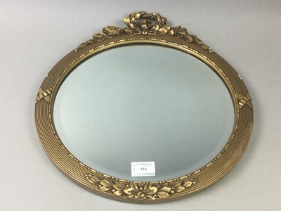 Lot 324 - A CIRCULAR BEVELLED WALL MIRROR