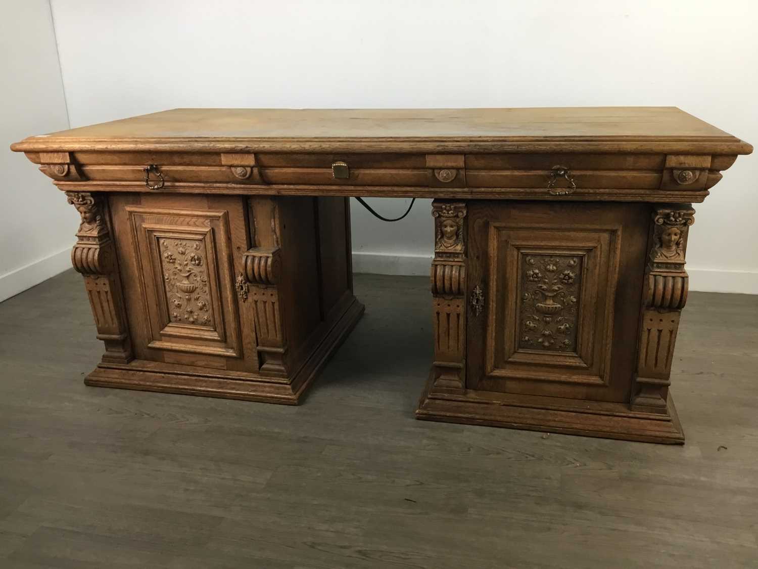 Lot 41 - AN EARLY 20TH CENTURY CARVED OAK DESK