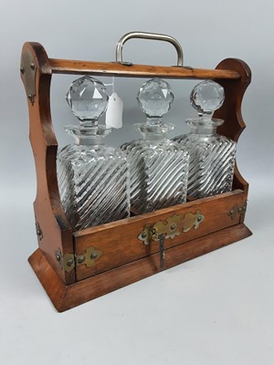 Lot 442 - AN OAK THREE BOTTLE TANTALUS