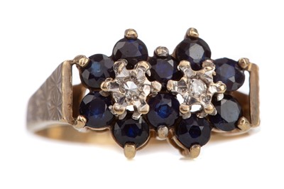 Lot 1250 - A SAPPHIRE DOUBLE CLUSTER RING
