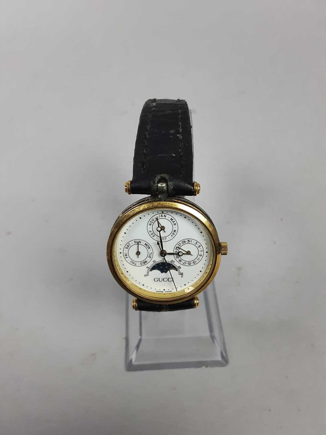 Lot 519 - A LADIES GUCCI TRIPLE MOON PHASE WRIST WATCH AND ANOTHER GUCCI WATCH