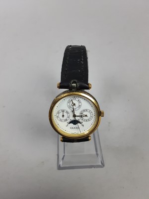 Lot 519 - A LADIES GUCCI TRIPLE MOON PHASE WRIST WATCH AND ANOTHER GUCCI WATCH