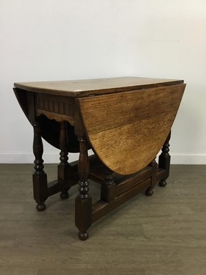 Lot 235 - AN OAK OVAL GATE LEG TEA TABLE