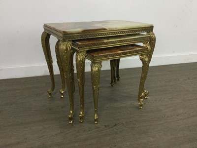 Lot 424 - A NEST OF THREE BRASS ONYX TABLES