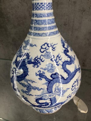 Lot 1086 - A CHINESE BLUE AND WHITE DRAGONS BOTTLE VASE