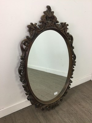 Lot 212 - AN OVAL BEVELLED WALL MIRROR