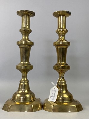 Lot 552 - A PAIR OF BRASS CANDLESTICKS