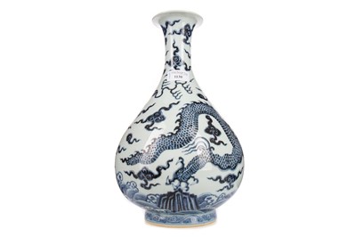 Lot 1130 - A CHINESE BLUE AND WHITE 'DRAGON' BOTTLE VASE