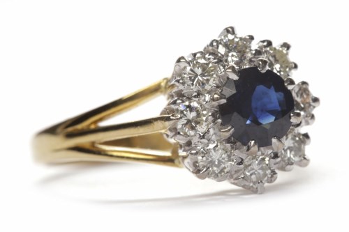 Lot 13 - SAPPHIRE AND DIAMOND CLUSTER RING the central...