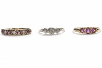 Lot 27 - THREE GOLD RINGS including a three stone...