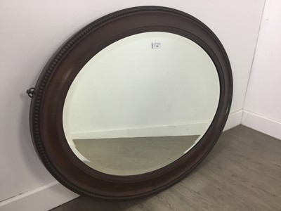 Lot 71 - A MAHOGANY OVAL WALL MIRROR