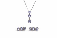 Lot 103 - TANZANITE PENDANT set with three round faceted...