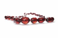 Lot 108 - GRADUATED BAKELITE BEAD NECKLACE formed by...