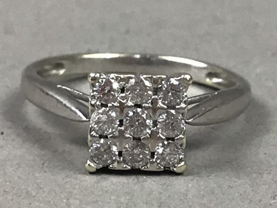 Lot 245 - A NINE CARAT WHITE GOLD AND DIAMOND NINE STONE RING