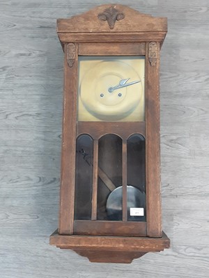 Lot 453 - AN EDWARDIAN OAK CASED WALL CLOCK