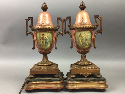 Lot 604 - A PAIR OF 19TH CENTURY CERAMIC AND TWIN HANDLED BRASS URNS