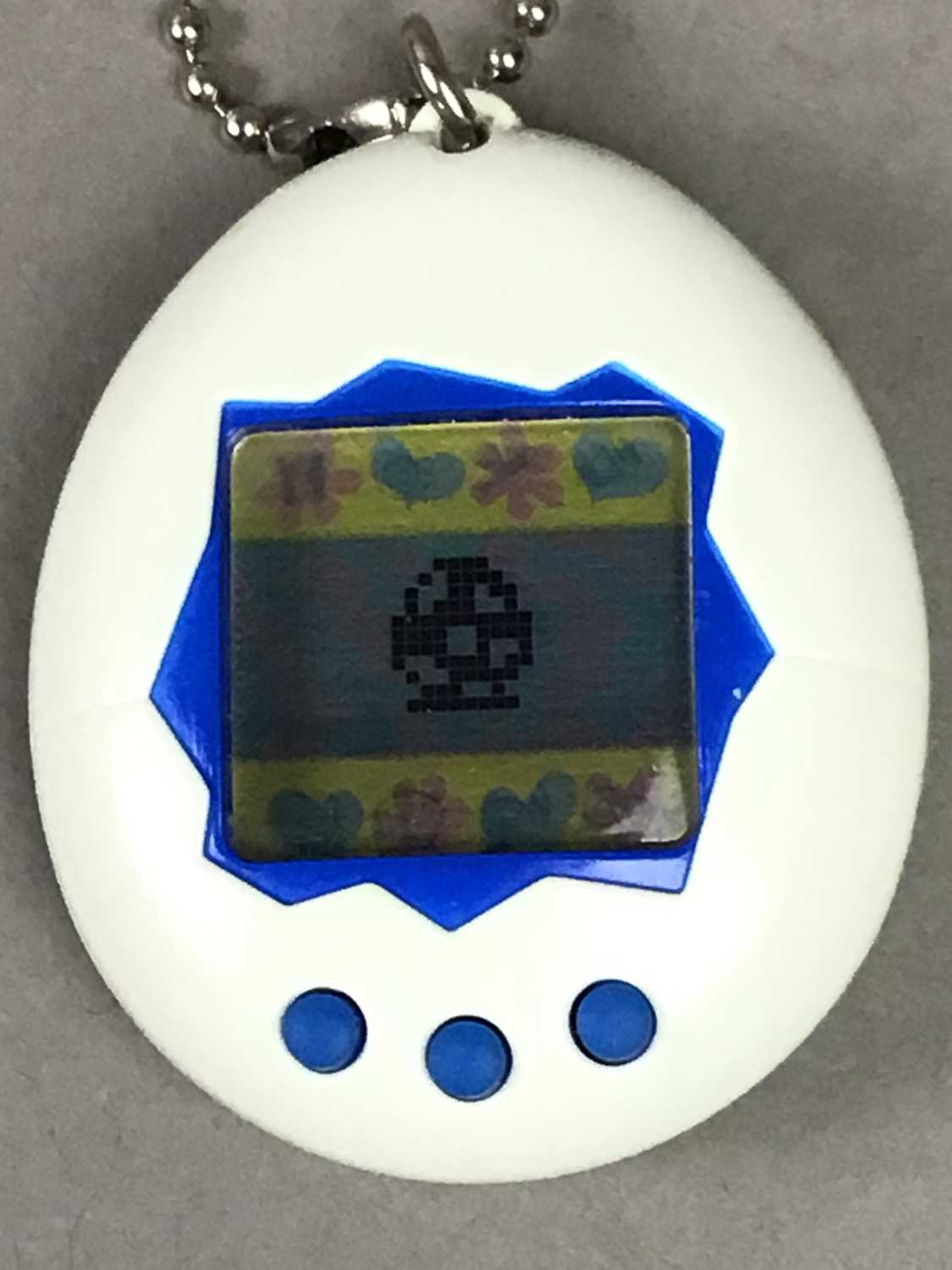 Lot 546 - AN ORIGINAL TAMAGOTCHI ELECTRONIC TOY AND OTHERS