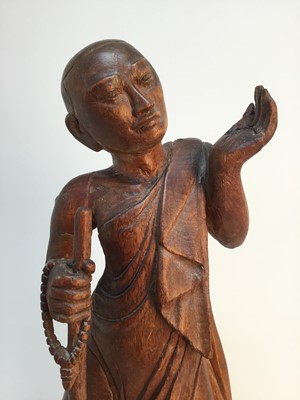 Lot 87 - A MID 20TH CENTURY CARVED TEAK FIGURE OF A BUDDHIST MONK
