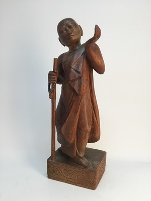 Lot 87 - A MID 20TH CENTURY CARVED TEAK FIGURE OF A BUDDHIST MONK