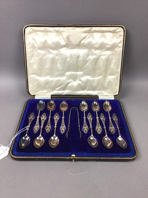 Lot 657 - A SET OF TWELVE SILVER TEASPOONS AND TONGS