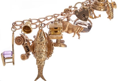 Lot 504 - A GOLD CHARM BRACELET