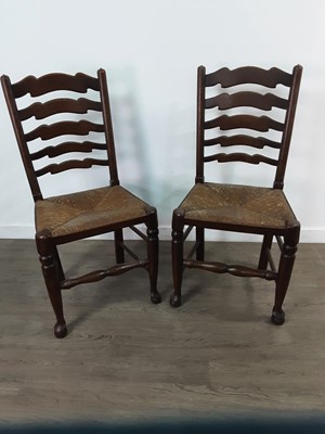Lot 314 - A SET OF SIX OAK LADDER BACK DINING CHAIRS WITH RUSH SEATS