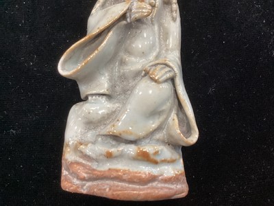 Lot 1244 - A SMALL CHINESE CELADON GLAZED POTTERY FIGURE OF GUANYIN