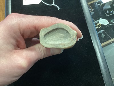 Lot 1244 - A SMALL CHINESE CELADON GLAZED POTTERY FIGURE OF GUANYIN