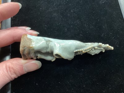 Lot 1244 - A SMALL CHINESE CELADON GLAZED POTTERY FIGURE OF GUANYIN