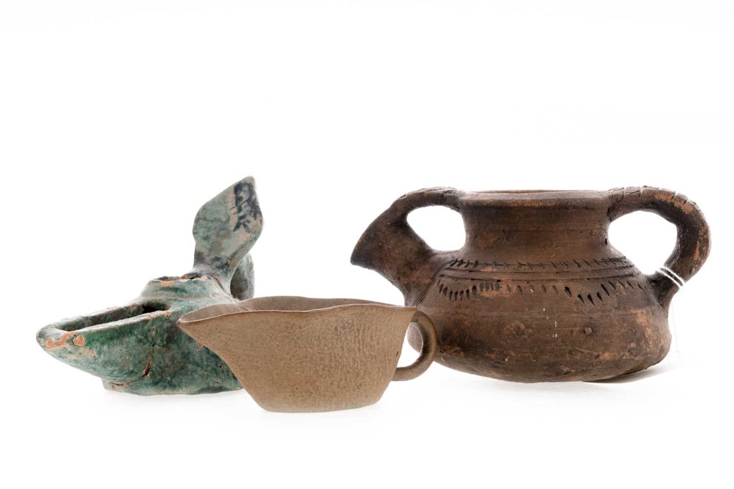 Lot 1245 - A PAKISTANI SWAT VALLEY KENDI, A JIN OIL STRAINER AND A TURQUOISE GLAZED LAMP
